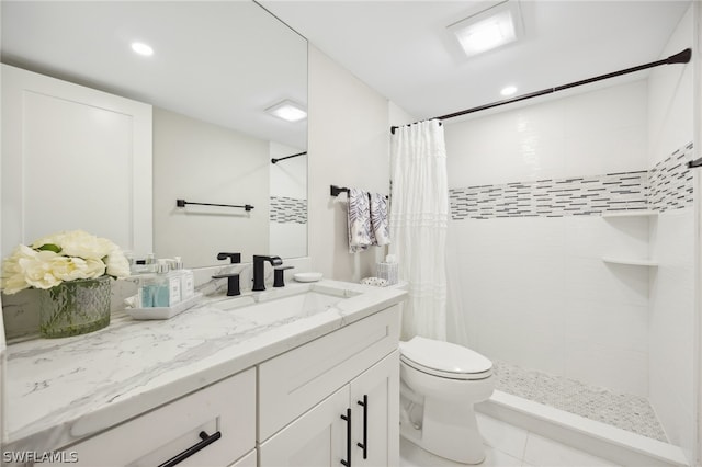 bathroom featuring curtained shower, tile floors, toilet, and large vanity