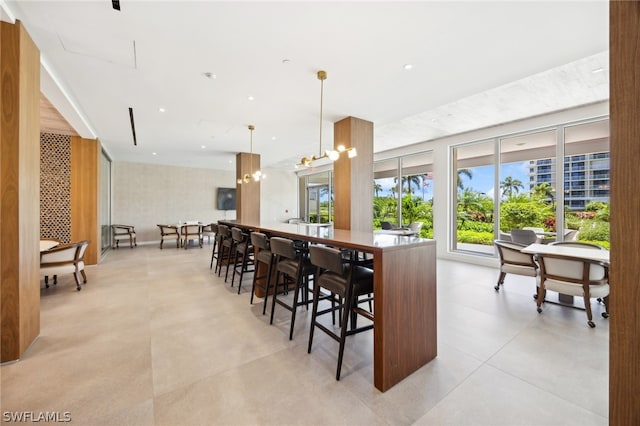 tiled dining space featuring a chandelier