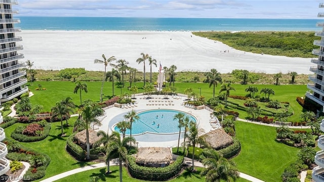 drone / aerial view with a beach view and a water view