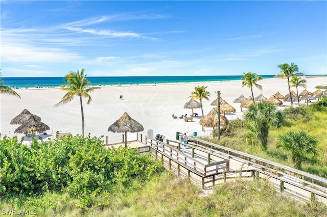 water view featuring a gazebo and a beach view