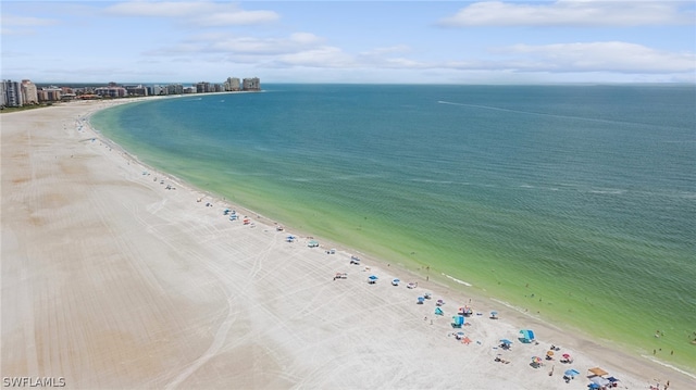 drone / aerial view with a beach view and a water view