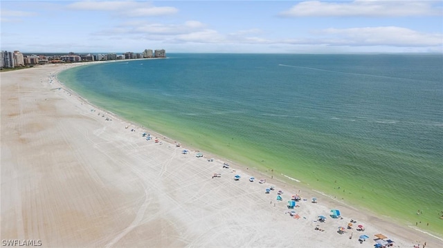 birds eye view of property with a beach view and a water view