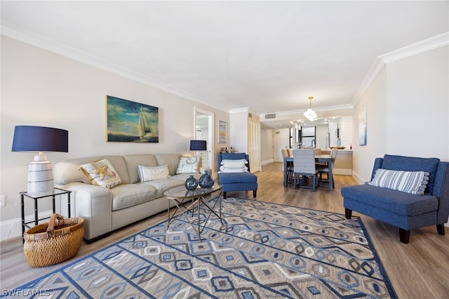 living room with ornamental molding and hardwood / wood-style floors