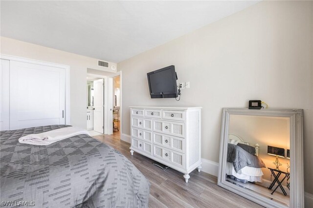 bedroom with hardwood / wood-style floors