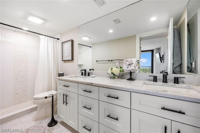 bathroom with vanity, curtained shower, and toilet