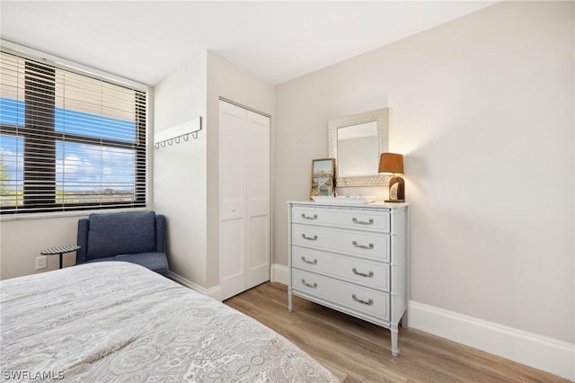 bedroom featuring a closet and light hardwood / wood-style flooring