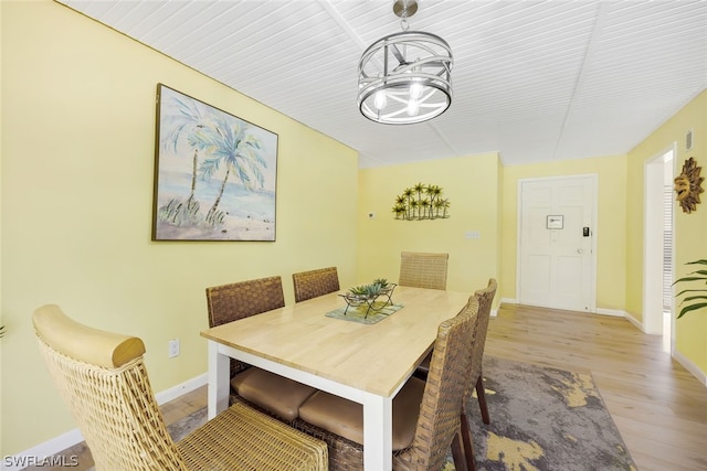 dining space featuring a notable chandelier and light wood-type flooring