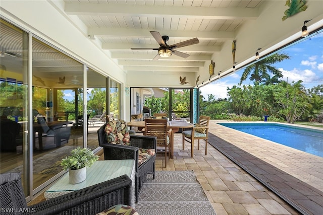 view of swimming pool with ceiling fan and a patio area