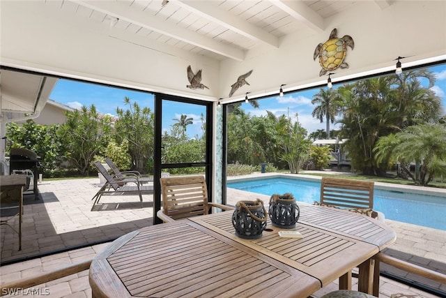 view of pool featuring a grill and a patio