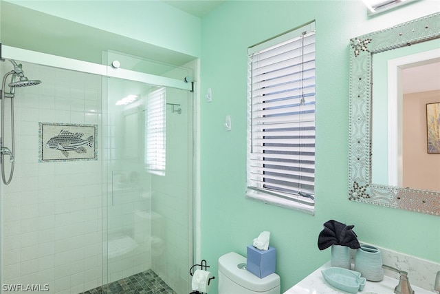 bathroom featuring toilet, walk in shower, and sink