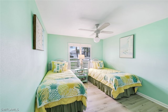 bedroom with ceiling fan and light wood-type flooring