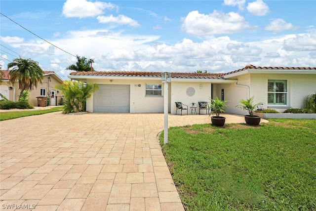 mediterranean / spanish-style home with a garage and a front yard