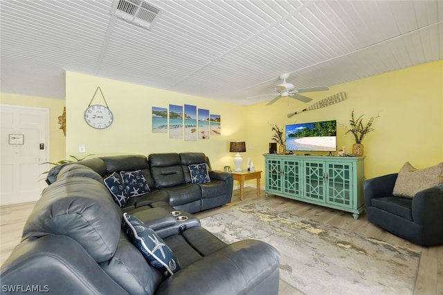 living room with ceiling fan and hardwood / wood-style floors