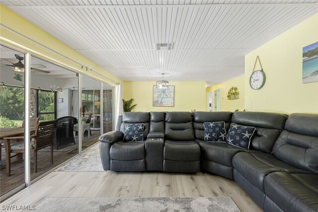 living room with ceiling fan and light wood-type flooring