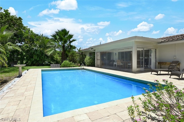 view of pool with a patio area and a sunroom