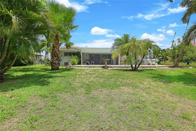 view of yard featuring central air condition unit and a sunroom