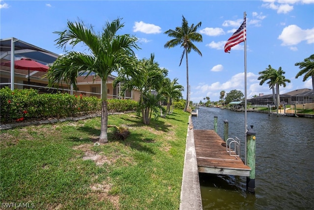 view of dock featuring a yard and a water view