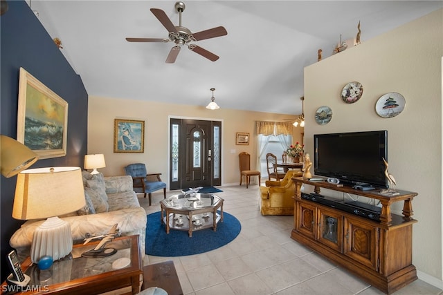 living room featuring vaulted ceiling, ceiling fan, and light tile patterned floors