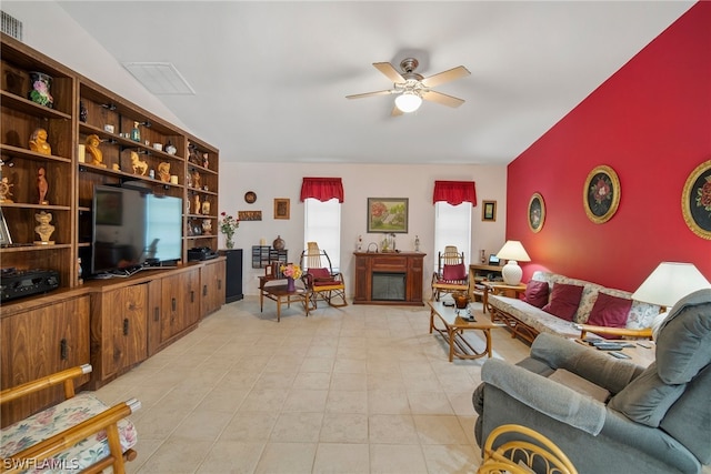 tiled living room with ceiling fan and lofted ceiling