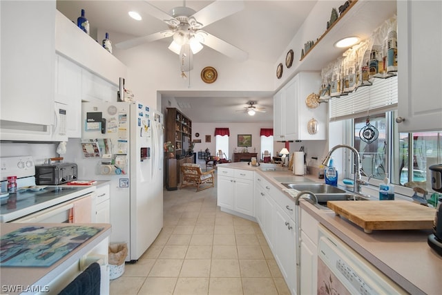 kitchen with white appliances, light tile patterned flooring, sink, and white cabinetry