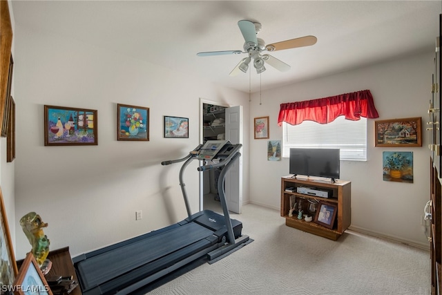 workout room featuring ceiling fan and light colored carpet