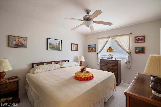 bedroom featuring ceiling fan and light carpet