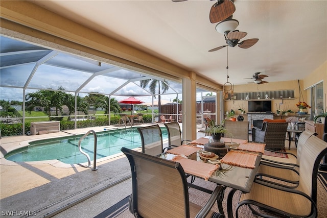 view of swimming pool featuring a lanai, a patio area, and a bar