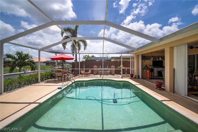 view of pool featuring a patio and glass enclosure