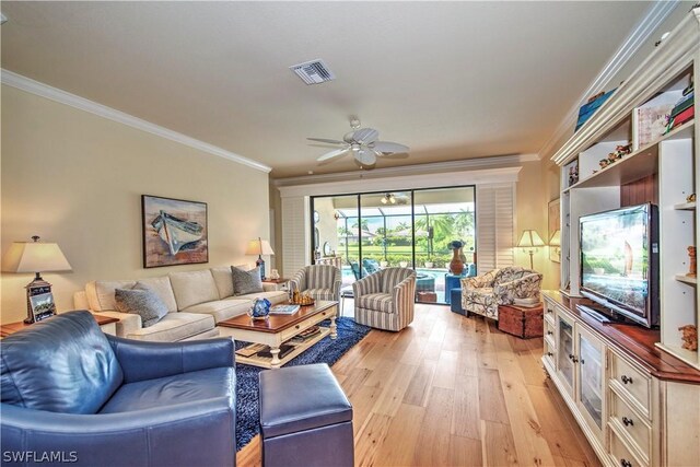 living room with light wood-type flooring, ceiling fan, and crown molding