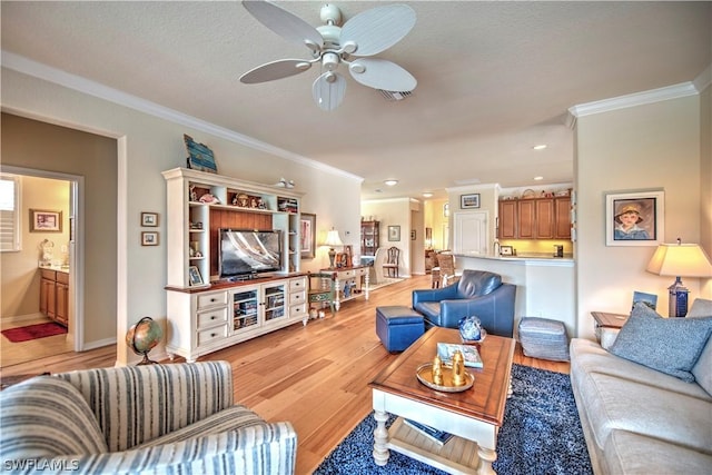 living room with ceiling fan, light hardwood / wood-style flooring, and ornamental molding