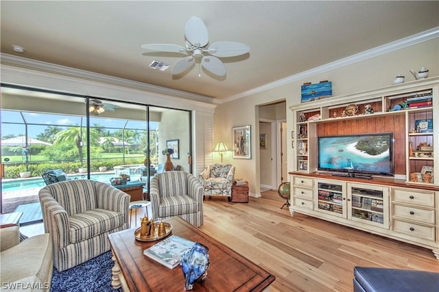 living room with light hardwood / wood-style flooring and ornamental molding