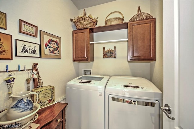 laundry room featuring cabinets and washing machine and dryer