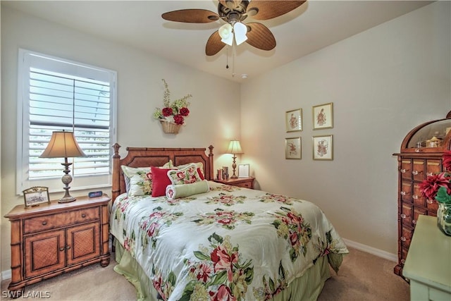 bedroom with ceiling fan and light colored carpet