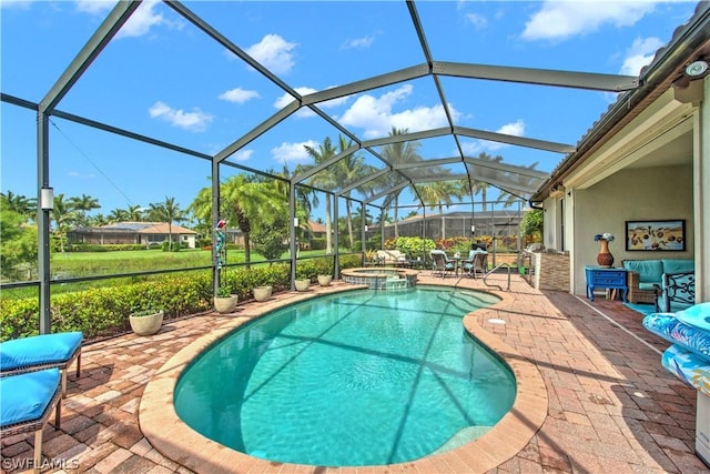 view of swimming pool featuring glass enclosure, an in ground hot tub, and a patio