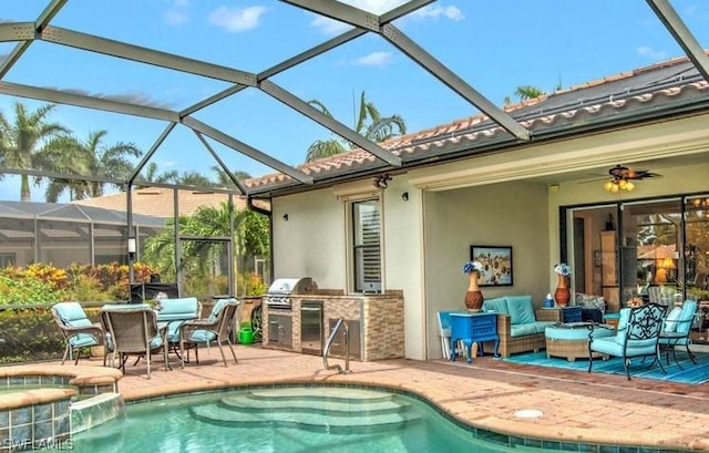 exterior space with an outdoor kitchen, a patio, and a pool with hot tub