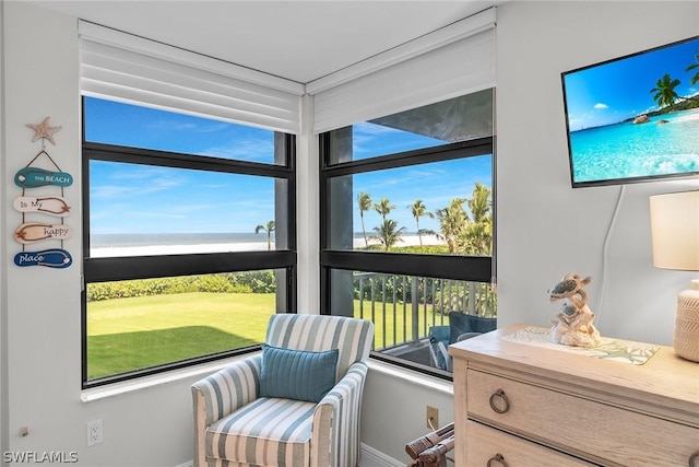 living area featuring a water view and plenty of natural light