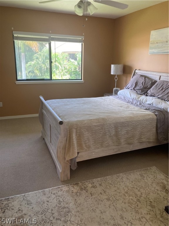 carpeted bedroom featuring ceiling fan