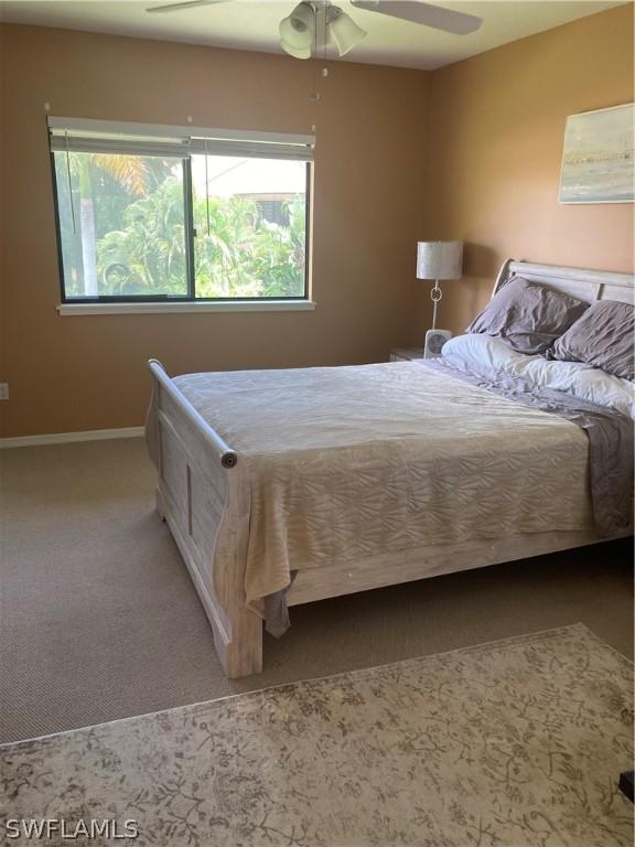 64 4th St Unit B201, Bonita Springs, FL 34134 - carpeted bedroom with baseboards and a ceiling fan