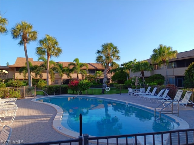 64 4th St Unit B201, Bonita Springs, FL 34134 - community pool featuring a patio area and a residential view