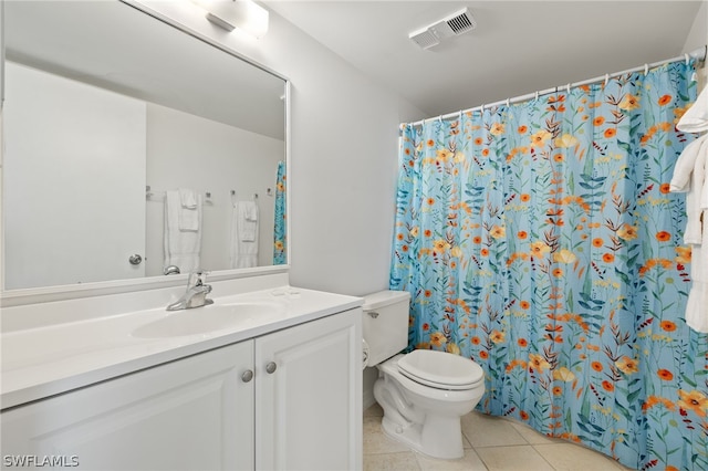 bathroom with vanity, tile patterned floors, and toilet