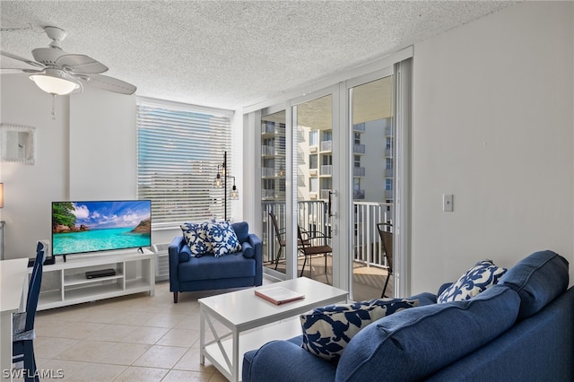 living room featuring a textured ceiling, light tile patterned flooring, and ceiling fan