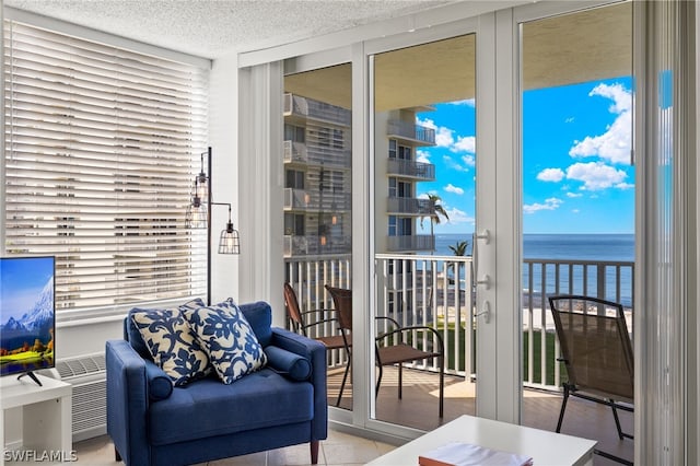 sunroom featuring a water view