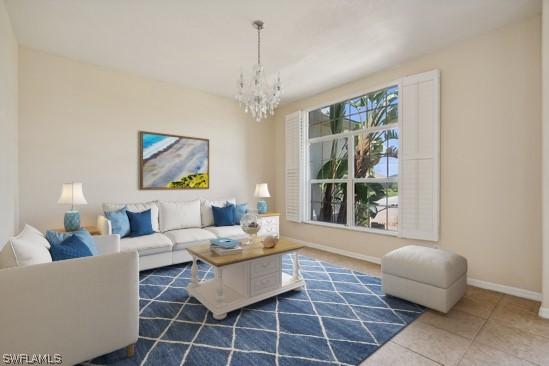 living room with an inviting chandelier, a wealth of natural light, and tile patterned floors