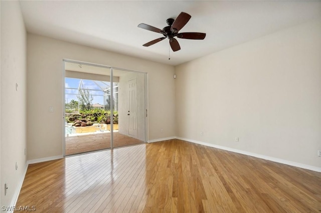 empty room with ceiling fan and light hardwood / wood-style flooring