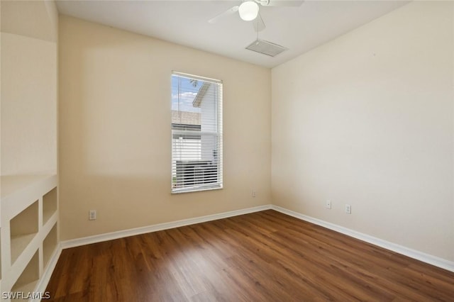 spare room featuring ceiling fan and dark hardwood / wood-style flooring