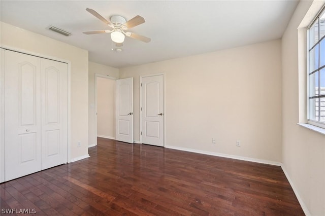 unfurnished bedroom with ceiling fan and dark hardwood / wood-style flooring