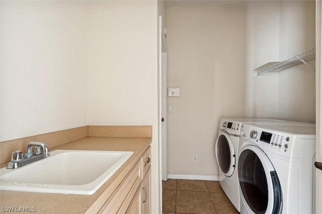 laundry area featuring cabinets, light tile patterned floors, washer and dryer, and sink