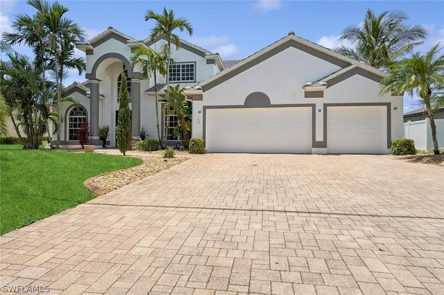 mediterranean / spanish-style house with a front lawn and a garage