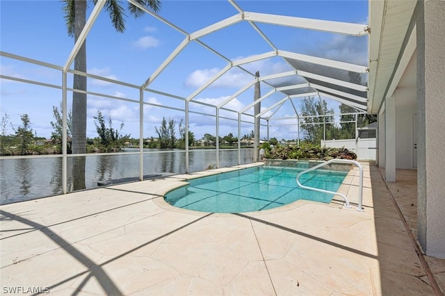 view of pool featuring glass enclosure, a water view, and a patio