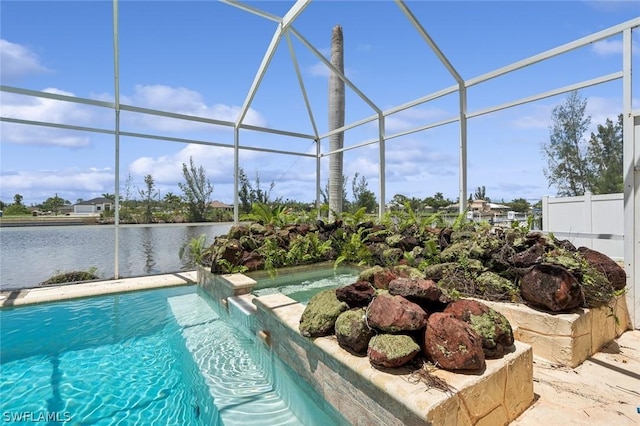 view of pool with glass enclosure, pool water feature, and a water view